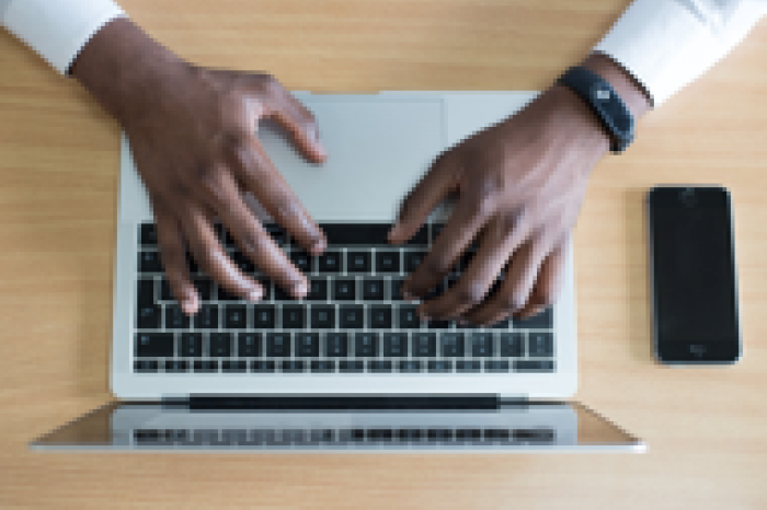 hands typing on laptop