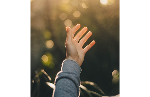 hand raising towards the sky