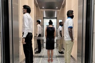people in an elevator looking away from each other